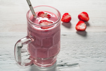 Strawberry smoothie in glass jar with handle,