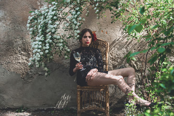 girl with wine glass sitting on chair