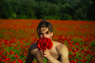 young man hold bouquet of red poppy flower