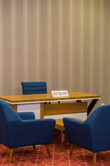 The sign with guest relation inscription is on the table. Guest accommodation in the hotel.  This service for the resolution of all complaints and problems among the hotel guests and tourists.