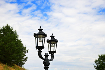 Fototapeta na wymiar Street metal retro style lantern on the sky background