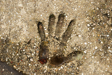 human palm print on a concrete slab