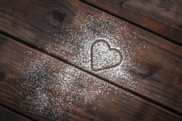 powdered sugar heart on wooden background