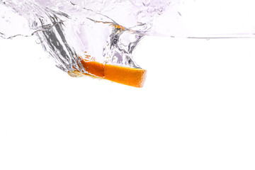 orange slice in water splash on white  background