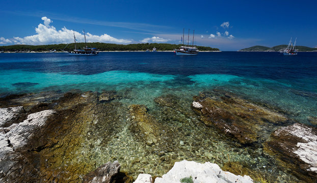 Boats in crystalline water by Paklinski islands, near Hvar, Croatia