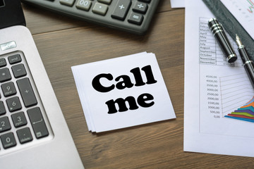 Sheet for inscriptions with text Call me on a table near a computer, a calculator, a fountain pen