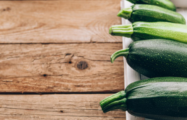 Fresh farmer organic zucchini on a wooden background