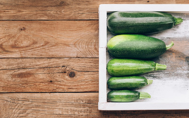 Fresh farmer organic zucchini on a wooden background