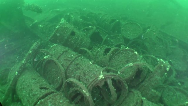Traces of shipwreck: rusted barrels of gasoline on the seabed.
