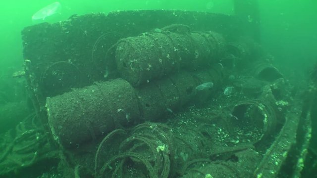 Traces of shipwreck: rusted barrels of gasoline on the seabed.
