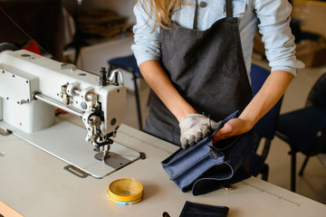 Leather handbag craftsman at work in a workshop