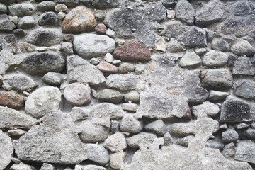 Old medieval stone wall. Medieval fortification photo texture. Rustic stone wall with cement plaster.