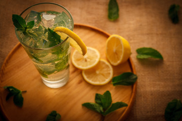 Mojito cocktail in a bur on a rustic table, selective focus