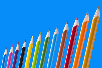 Pencils 12 pieces of bright colors on a blue background