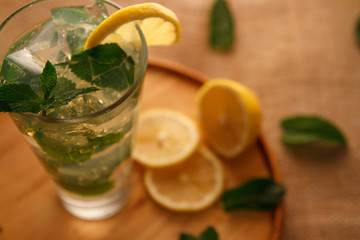 Mojito cocktail in a bur on a rustic table, selective focus