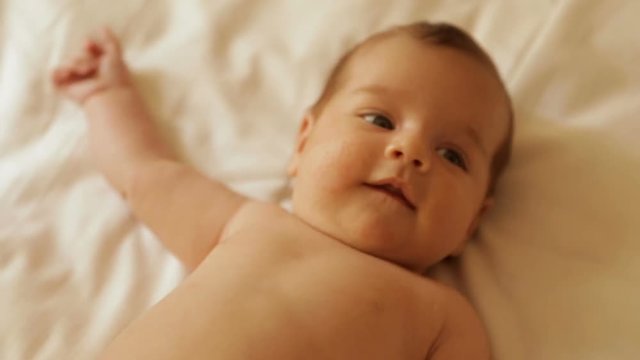 A newborn baby lies on its back
