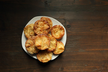 White dish with muffins on a wooden background.