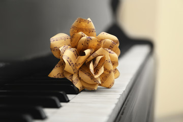 Fototapeta premium Rose made of music notes on piano keys