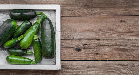 Fresh farmer organic zucchini on a wooden background