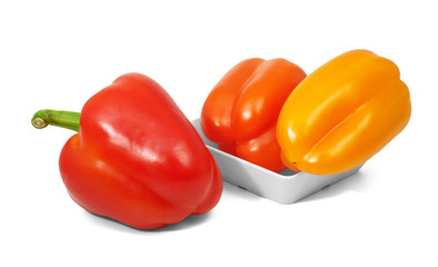 Red and orange bell pepers in horizontal position on white background
