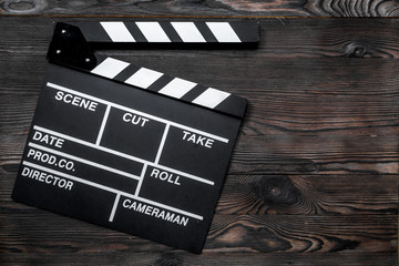 Movie clapperboard on wooden table background top view copyspace