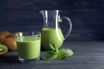 Delicious yogurt smoothie with kiwi  on wooden background