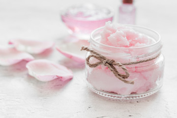 Fototapeta na wymiar rose organic cosmetics with salt, cream and oil on white table background