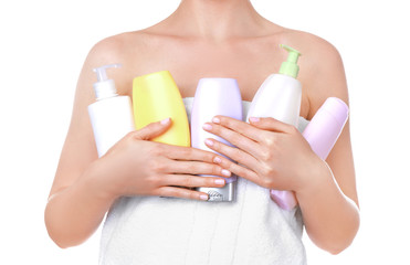 Fototapeta premium Young woman after shower with cosmetic products on white background, closeup