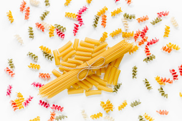 Assortment of different shape italian pastas on white background top view
