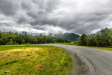 Fototapeta na wymiar Beautiful road goes through norwegian mountains in Troms country, Norway.