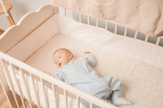 Cute little baby sleeping in cradle at home