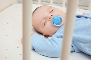 Cute little baby sleeping in cradle at home