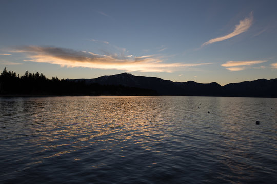 Lake Tahoe sunset over water with mountain silhouette