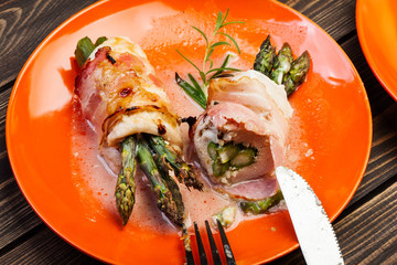 Baked fresh asparagus wrapped in chicken and bacon