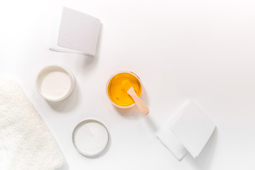 Concept depilation with wax and sticks on white background top view copyspace