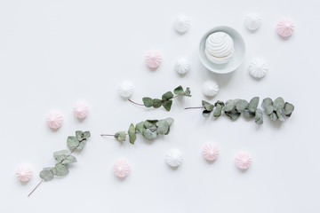 sweet marsh-mallow and flowers on woman white desk background top view