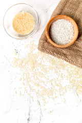 paella ingredients with rice on white table background top view mock up