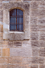 Medieval stone wall with barred window background