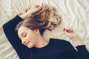 Naklejka premium Beautiful young girl sleeping in the bedroom.