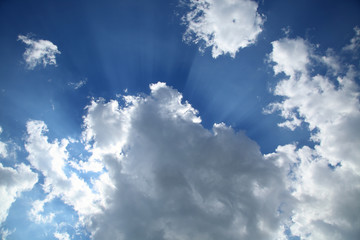 Beautiful sky with clouds and sunlight. Sun rays shining through the storm clouds.