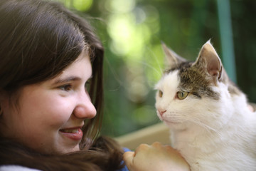 teen girl hug cat close up outdoor summer photo