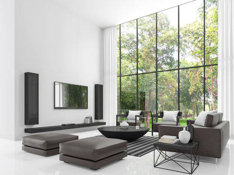Modern white living room 3d rendering image.The living room has a high ceiling. There is a white wall,floors and decorate with black tone furniture and there has a  large windows overlook the garden