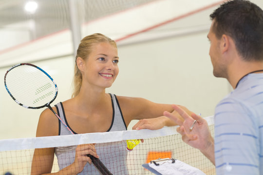 positive tennis players chatting on the court