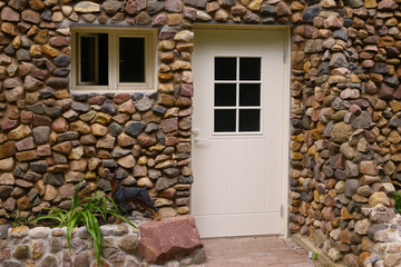 stony designed wall with door and window close up photo