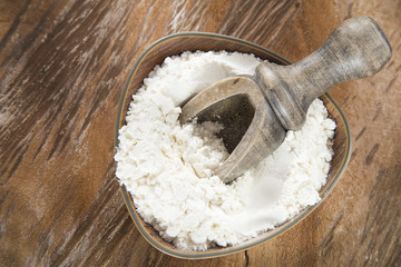 Wheat flour in wooden bowl