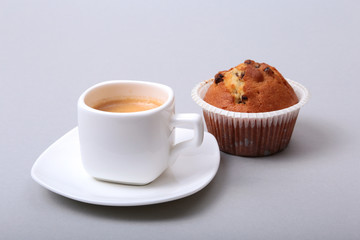 Classic espresso in white cup with homemade cake and chocolate on white background.