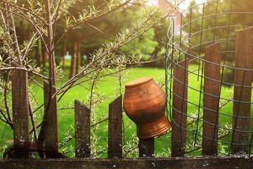 glue terracota pot  on the fence close up summer photo