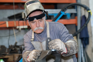 portrait factory senior welder in workshop