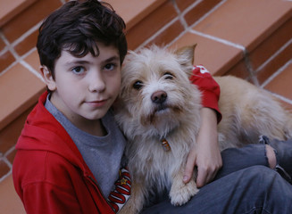 teenager boy hug terrier dog  close up photo 