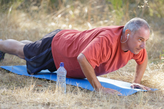 Man Doing Pushups Outdoors In Nature